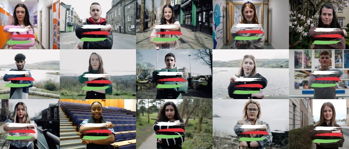 Students showing the symbol of the peace and goodwill message with their arms