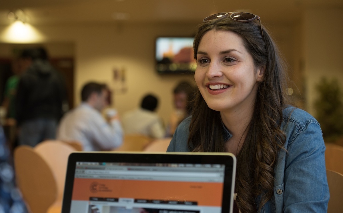 Student in Callaghans with a laptop in the foreground