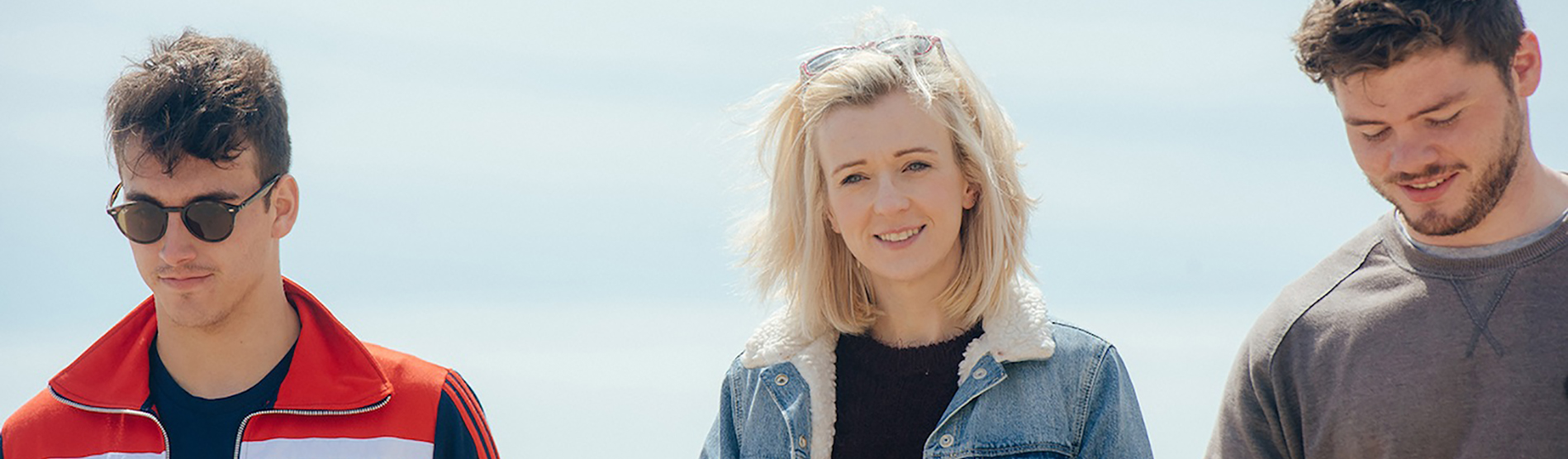 Three students walking on the Swansea beach