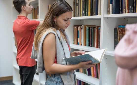 Student reading a book in the library