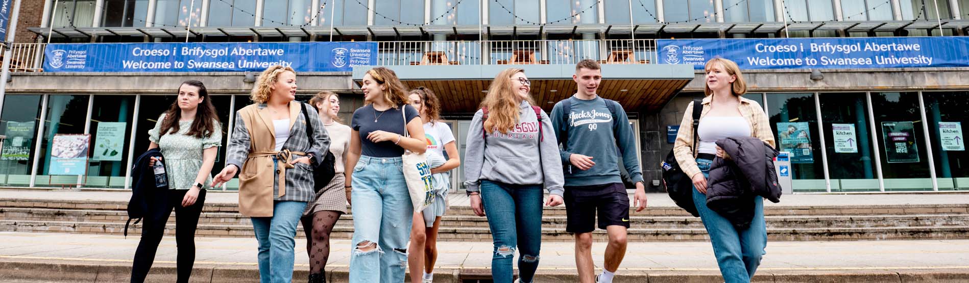 Group of students walking by Fulton House on the Singleton Campus