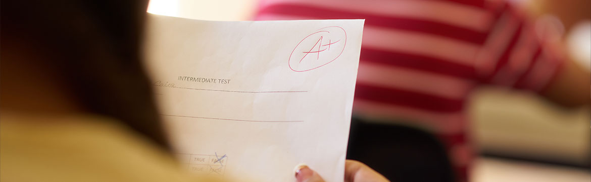 A student holding a graded test