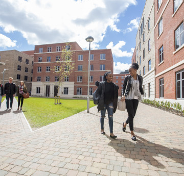 students walking across bay courtyard