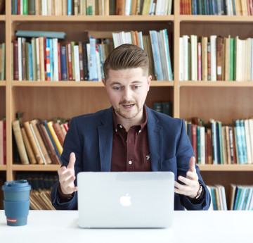 a male lecturer taking a video call