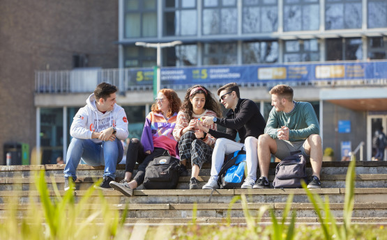 A group of students sat on the steps of Fulton House