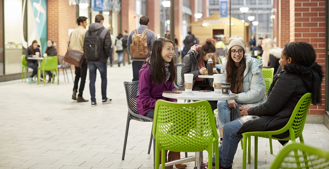 Three students sitting in a cafe.