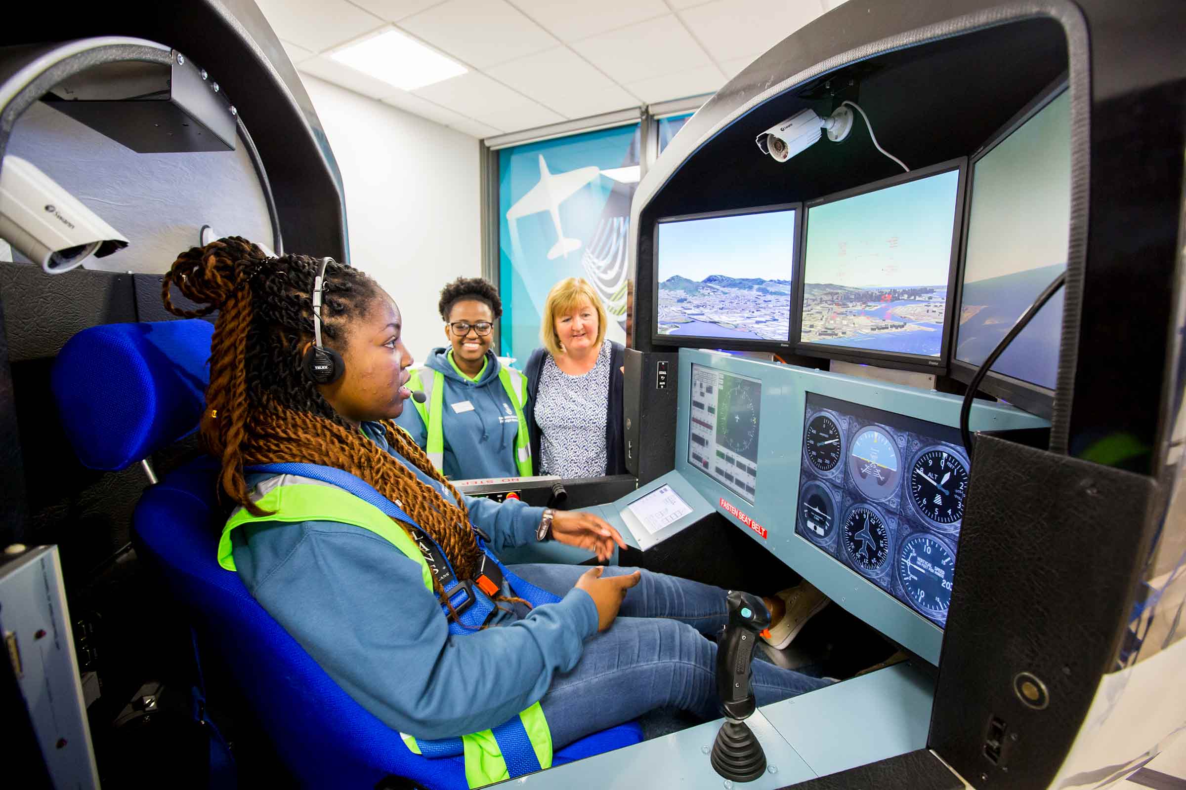 Students using flight simulator equipment