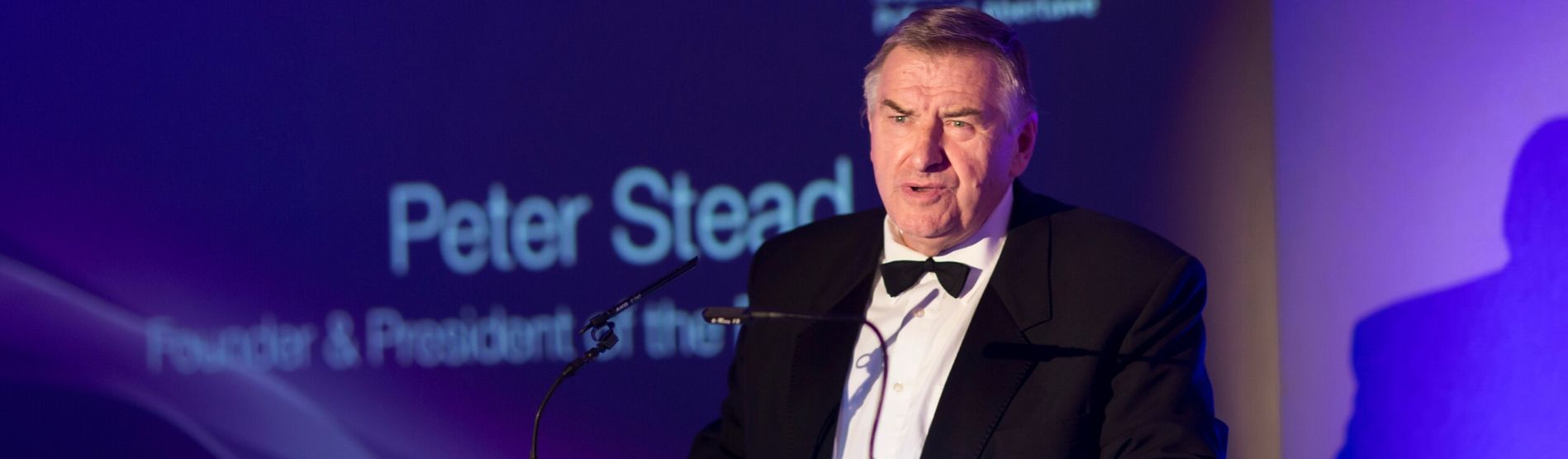 Peter Stead in black tie, giving a speech.