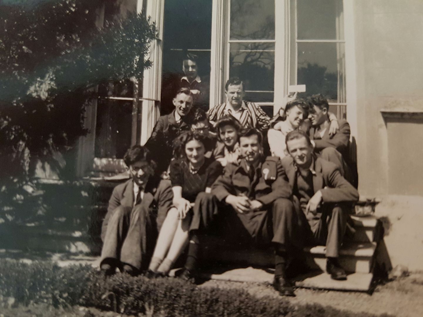 black and white image of students sitting on Singleton Abbey stairs 