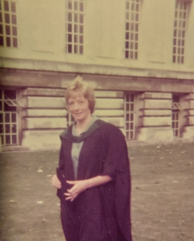 Photo of alumni with graduation cap 