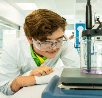 lab student looking into microscope