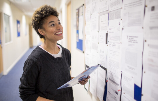 Woman looking at a notice board