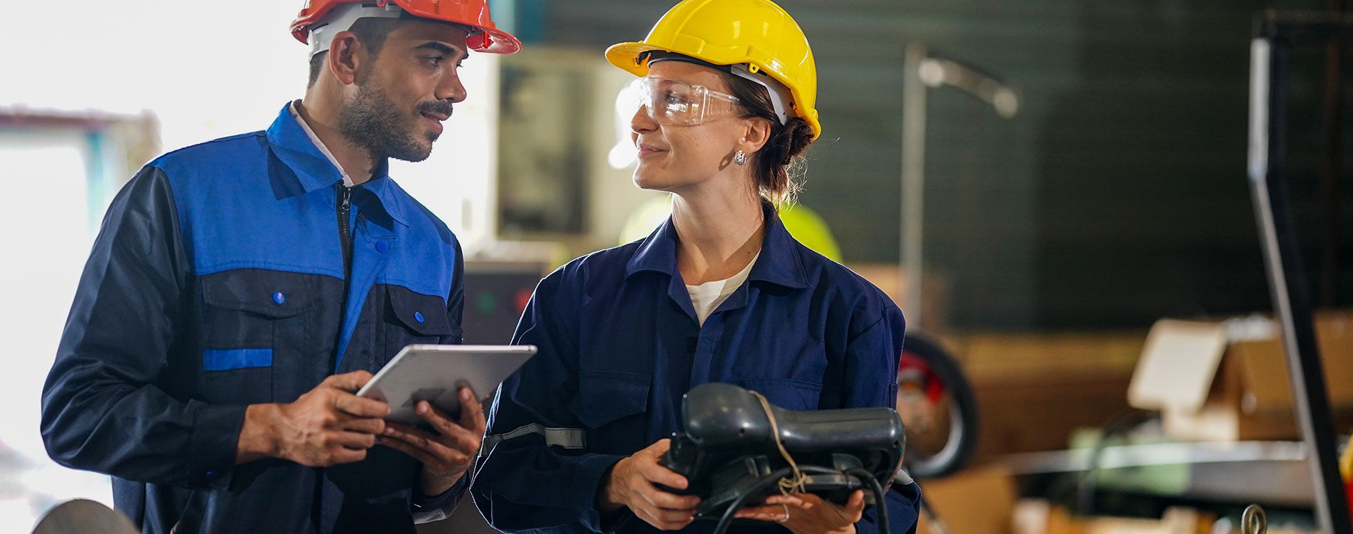 two industrial engineering talking wearing hard hats