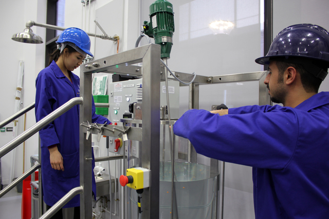 Male and female student completing an experiment