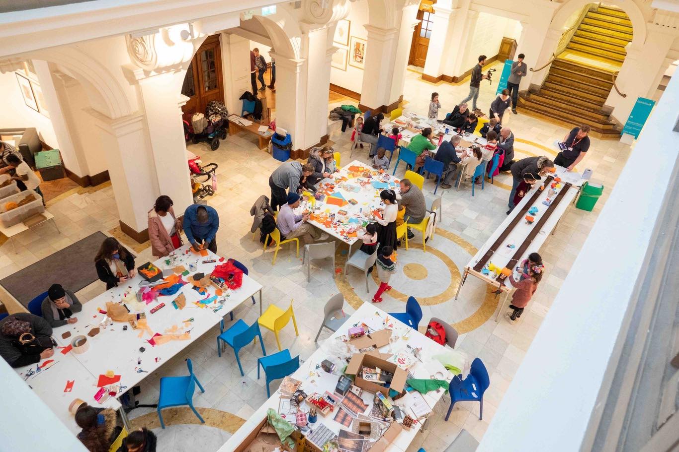 Groups of people doing arts and crafts at tables