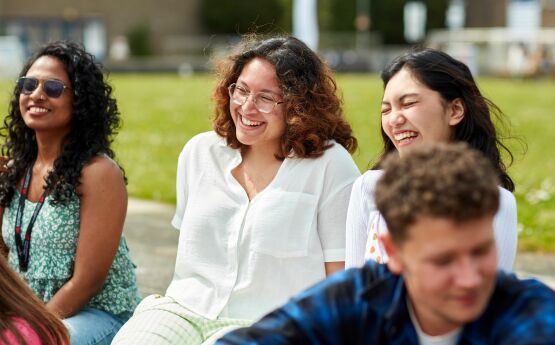 image of students sat on grass