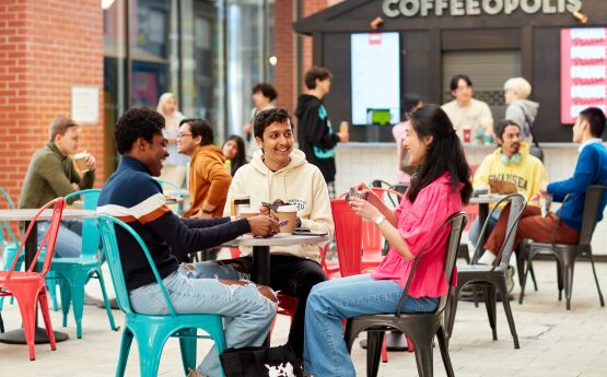  Three students sitting drinking coffee