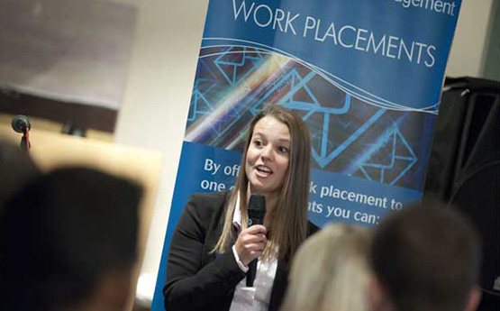 A female student speaking in front of an audience