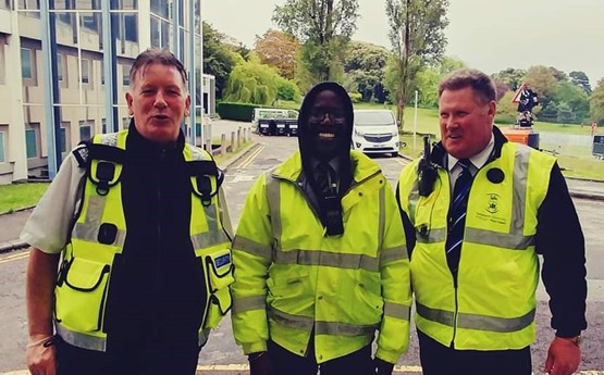 Geraint and two colleagues wearing high visibility jackets at Grad Ball