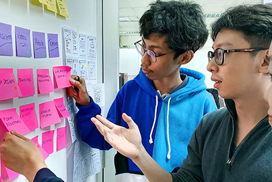 Two students looking at research notes.