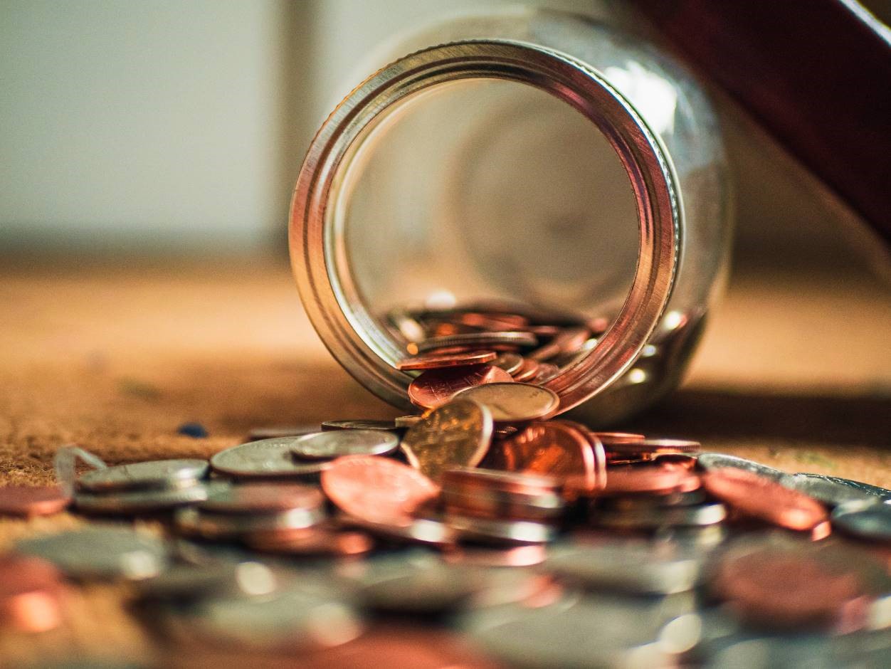 Coins falling out of a jar 