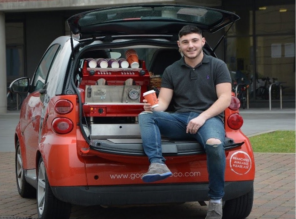 boy sitting in the boot of a car