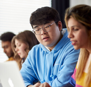 Students looking at a laptop 