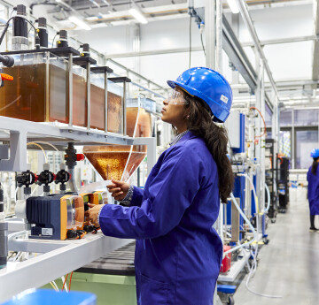 Student with chemical engineering equipment in lab