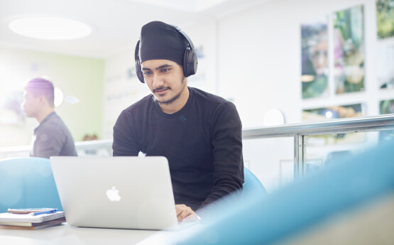 Male student on a laptop