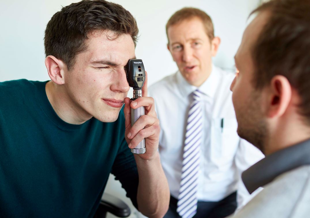 Student completing eye exam with lecturer observing 