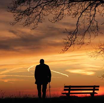 Man sitting next to a tree 