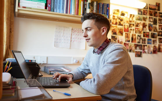 Student sat at laptop