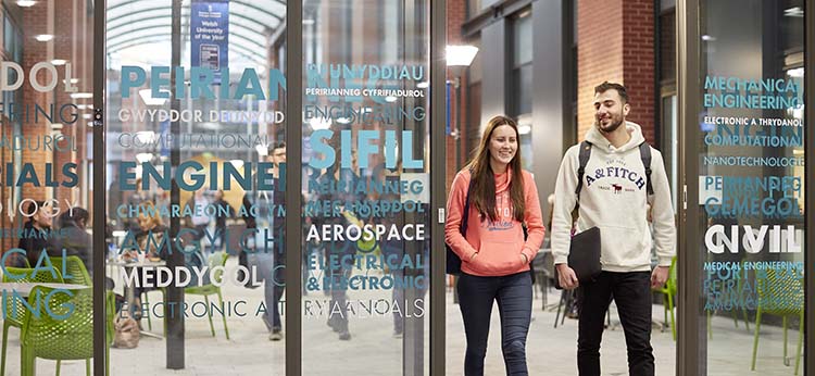 Female and male student walking through Engineering Central