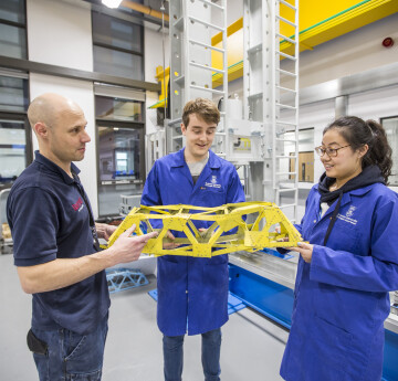 Civil students in structures lab with a technician