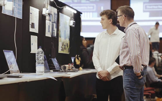 Student and lecturer stood talking 