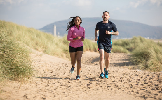 Students running on the beach 