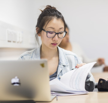 Student sat at a laptop