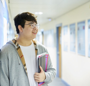 student holding book