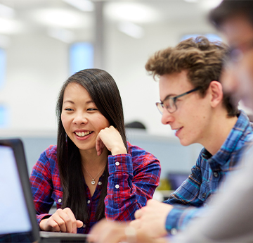 Students around data on a laptop