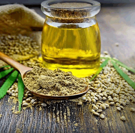 jar of cannabidiol and hemp power on a wooden spoon