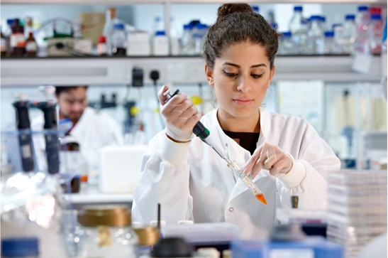 female scientist performing experiment in a lab