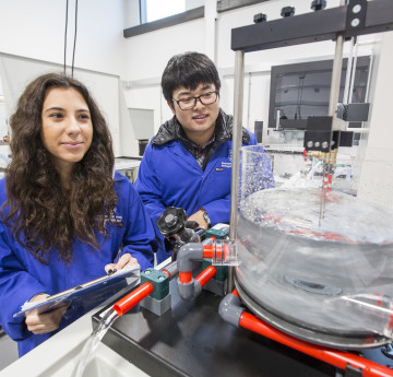 Students in Fluid lab with blue lab coats