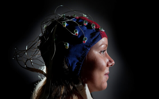 a person wearing a sensor cap, black background.