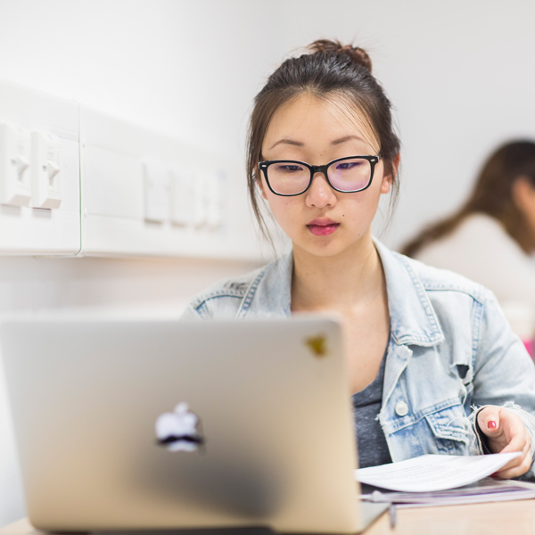 A student working at a laptop