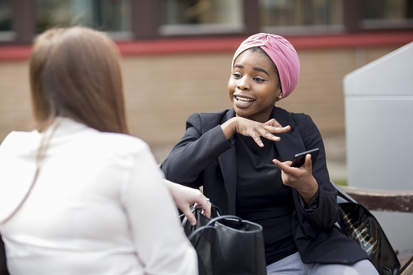 Two women talking on a bench