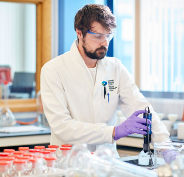 Man in lab coating working in a science lab