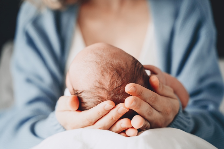 Woman holding newborn baby