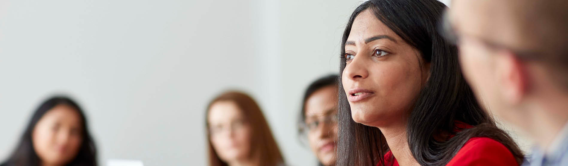 female talking at a board meeting