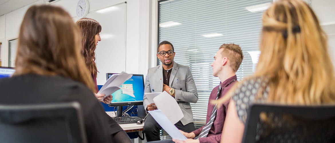 group of students in a meeting working together