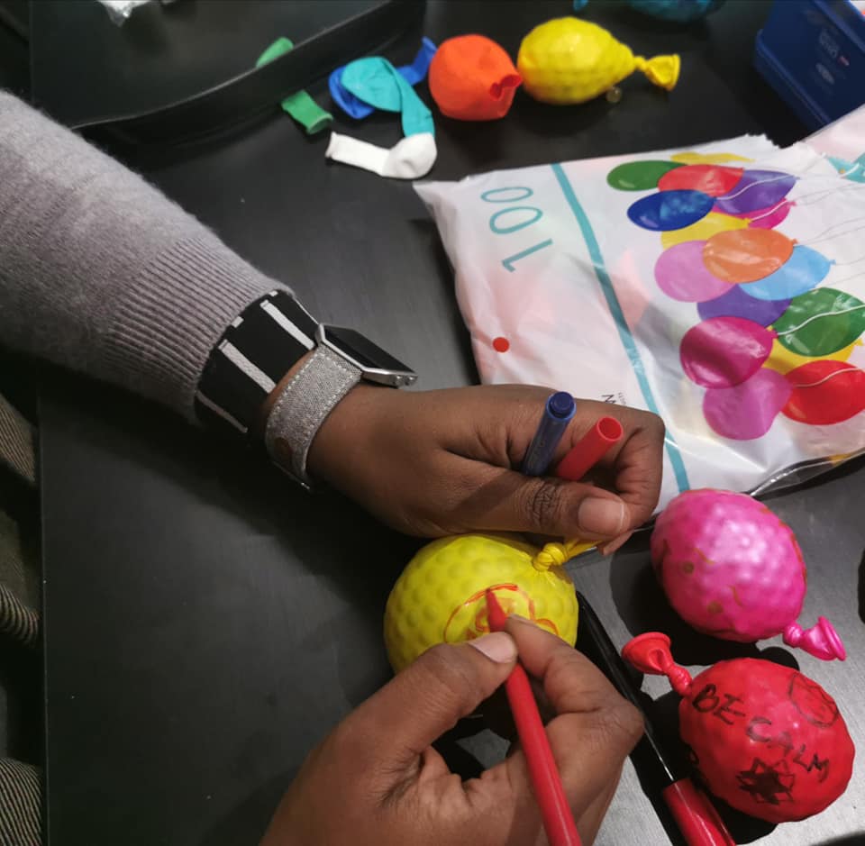 Someone decorating coloured balloons